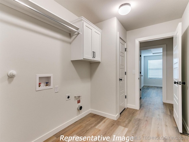 laundry room with light wood-type flooring, hookup for a washing machine, cabinets, and hookup for an electric dryer