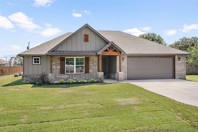 view of front of house featuring a front lawn and a garage