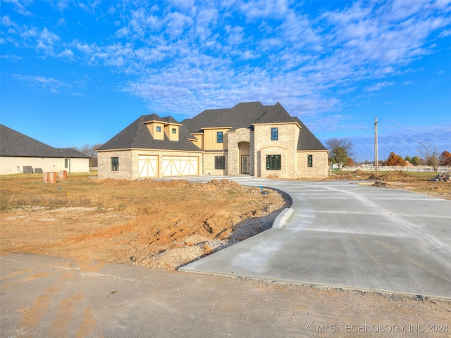 french country home with a garage