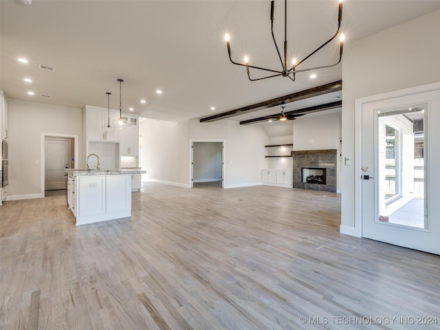 4008 W Yuma St S, Broken Arrow, OK 74011 - kitchen with white cabinetry, open floor plan, a center island with sink, baseboards, and beam ceiling