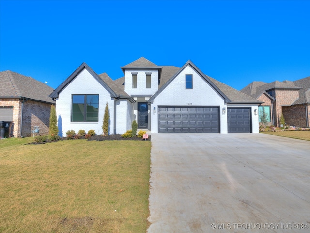 view of front of house with a garage and a front lawn