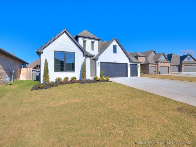 view of front facade with a front yard and a garage