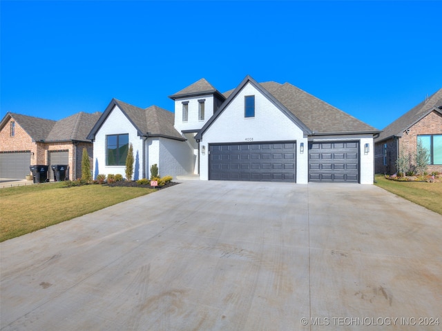 view of front facade with a garage and a front lawn