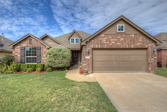 view of front of property with a front yard and a garage