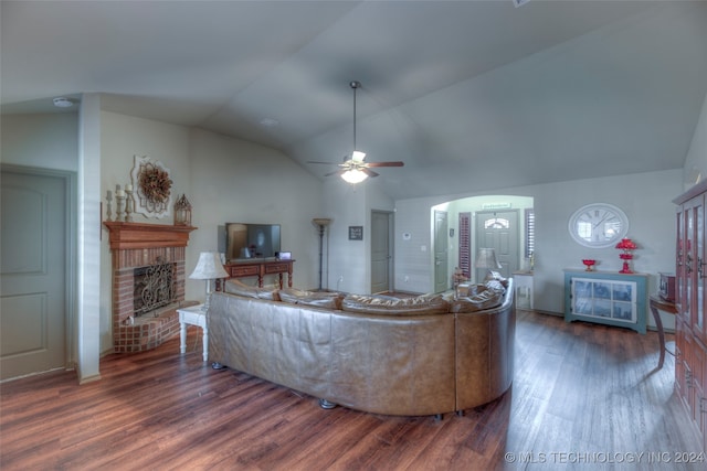 living room featuring lofted ceiling, ceiling fan, dark hardwood / wood-style flooring, and a brick fireplace