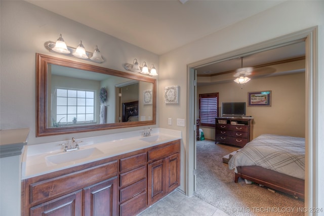 bathroom with tile patterned flooring, vanity, and ceiling fan