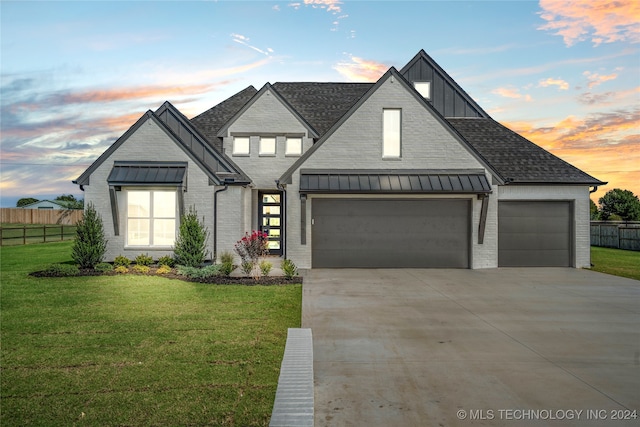 view of front facade with a garage and a lawn