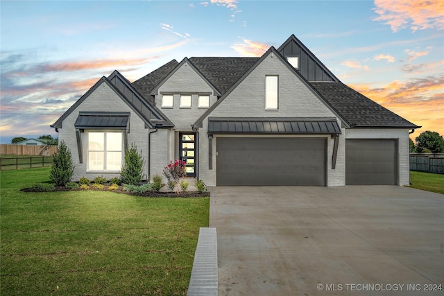 modern inspired farmhouse featuring brick siding, a standing seam roof, board and batten siding, and fence