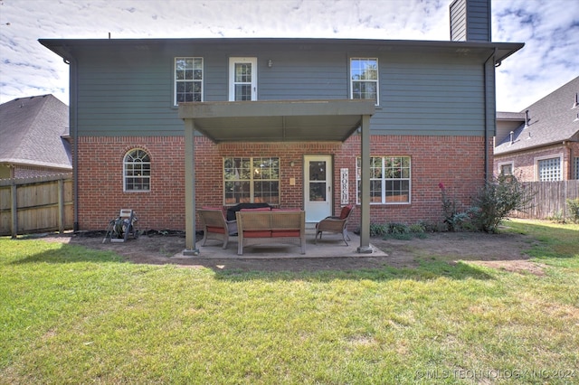 back of property featuring outdoor lounge area, a patio, and a lawn