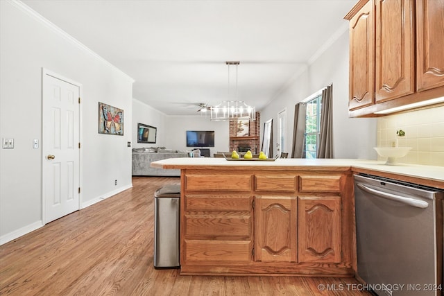 kitchen featuring pendant lighting, crown molding, light hardwood / wood-style flooring, stainless steel dishwasher, and a notable chandelier