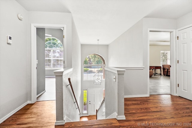 entrance foyer featuring wood-type flooring and an inviting chandelier