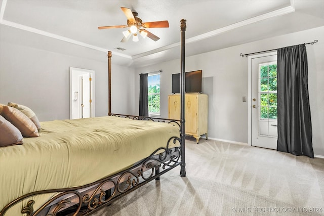 bedroom with access to exterior, ceiling fan, light colored carpet, and multiple windows