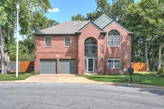 view of front of home featuring a garage and a front yard