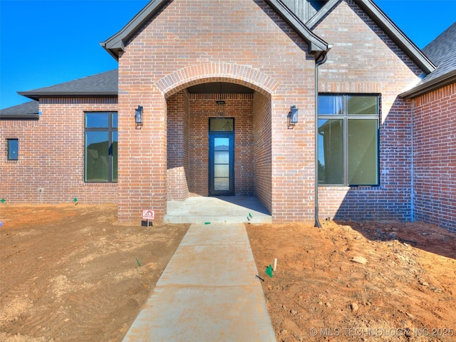 view of exterior entry featuring a patio area