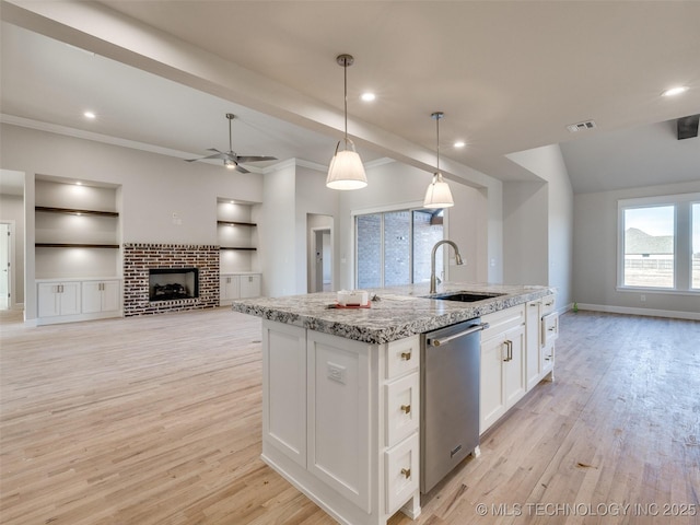 kitchen with sink, hanging light fixtures, dishwasher, a kitchen island with sink, and white cabinets