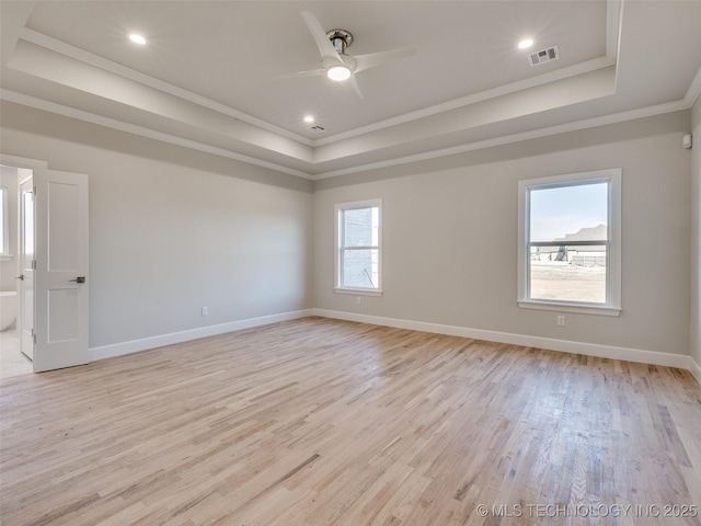 unfurnished room featuring crown molding, light hardwood / wood-style floors, a raised ceiling, and ceiling fan