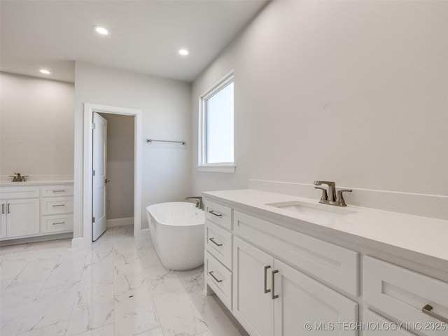 bathroom with vanity and a tub to relax in