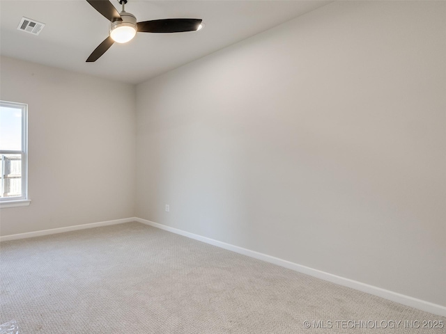 spare room featuring light carpet and ceiling fan