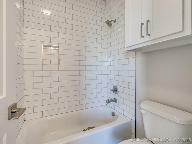 bathroom featuring tiled shower / bath and toilet