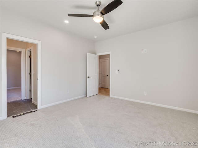 unfurnished bedroom featuring ceiling fan and light colored carpet