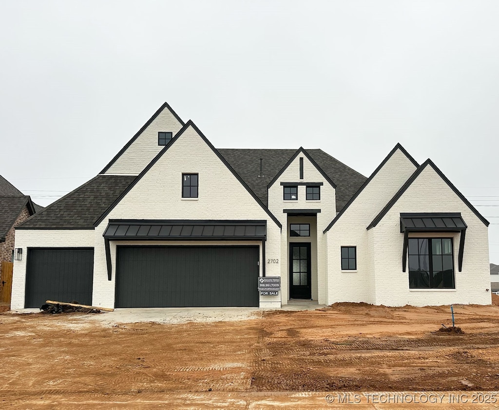 modern inspired farmhouse featuring a garage