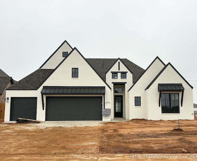 modern inspired farmhouse featuring a garage