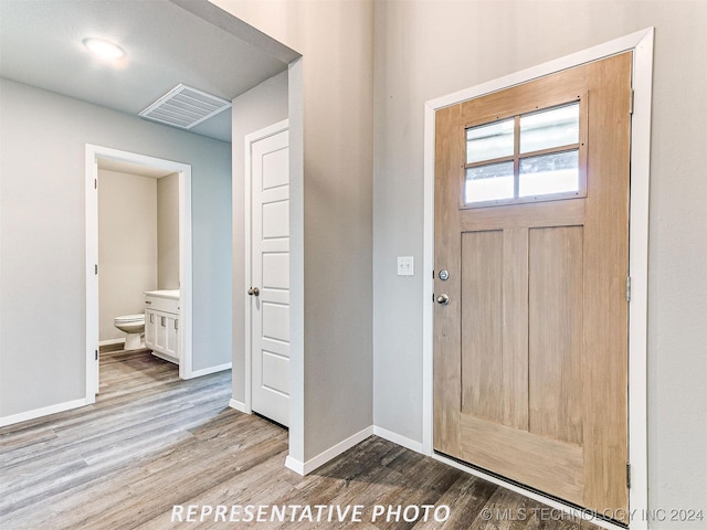 foyer with wood-type flooring