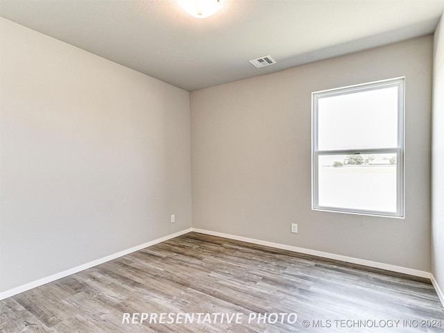 spare room featuring light hardwood / wood-style flooring