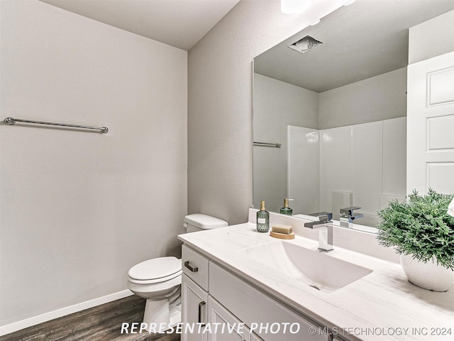 bathroom featuring hardwood / wood-style floors, toilet, and vanity