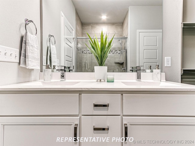 bathroom with vanity and a shower with shower door