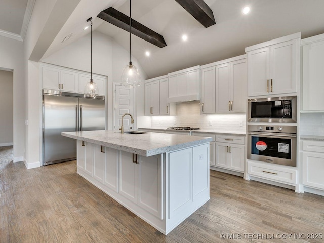 kitchen featuring built in appliances, sink, beam ceiling, and white cabinetry