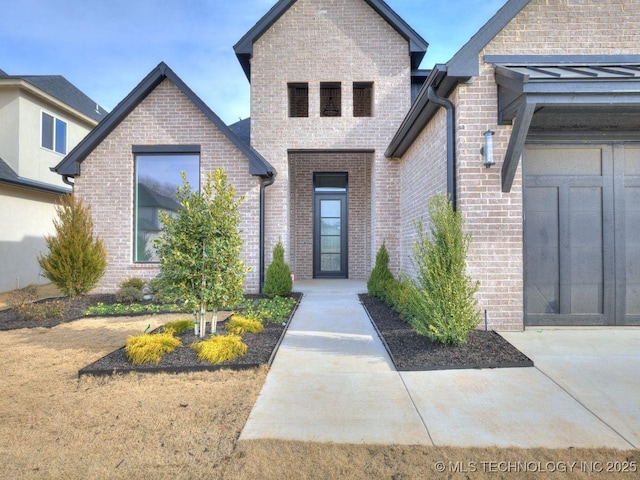 doorway to property with a garage