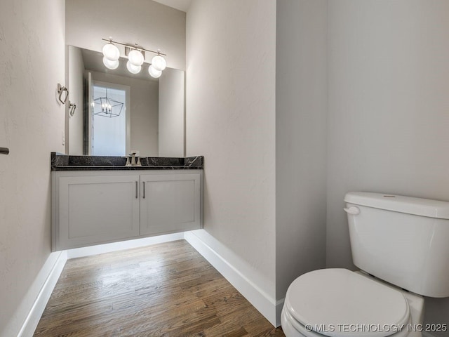 bathroom featuring hardwood / wood-style flooring, vanity, and toilet