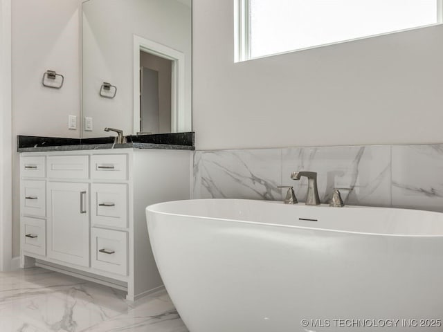 bathroom featuring vanity and a bath