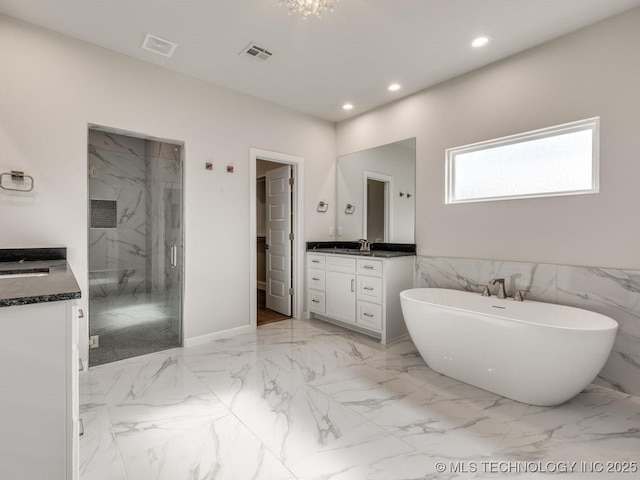 bathroom with vanity, shower with separate bathtub, and tile walls