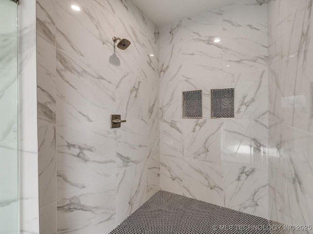 bathroom with a tile shower