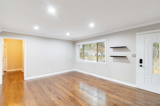 entrance foyer featuring hardwood / wood-style floors and ornamental molding