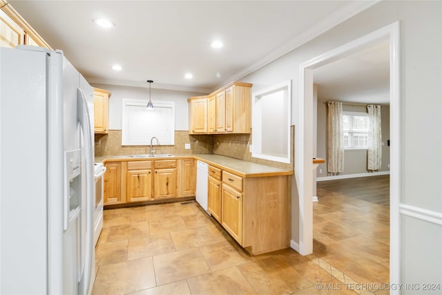 kitchen with pendant lighting, light brown cabinets, sink, and white appliances