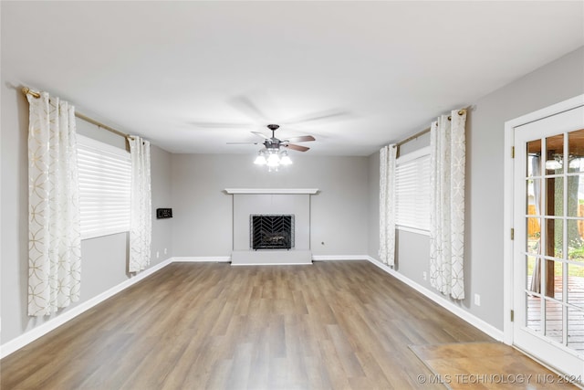 unfurnished living room featuring ceiling fan and light hardwood / wood-style flooring