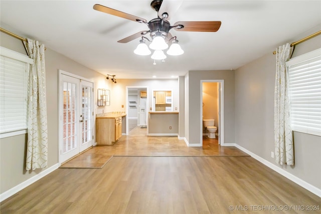 unfurnished living room with ceiling fan and light hardwood / wood-style floors