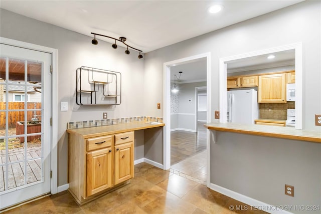 kitchen with white appliances, light brown cabinetry, decorative backsplash, and ornamental molding