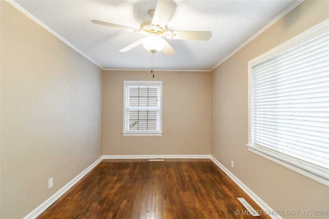 spare room featuring dark hardwood / wood-style flooring, ceiling fan, and crown molding