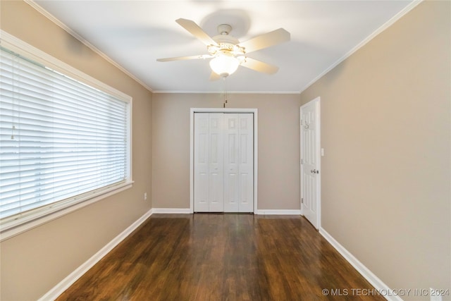 unfurnished bedroom featuring ceiling fan, crown molding, a closet, and dark hardwood / wood-style flooring