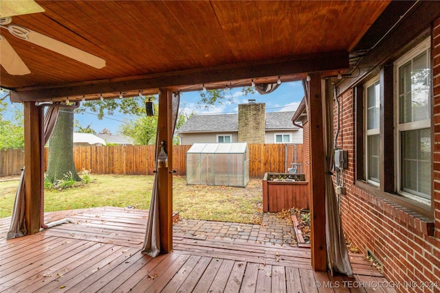 wooden deck featuring a shed