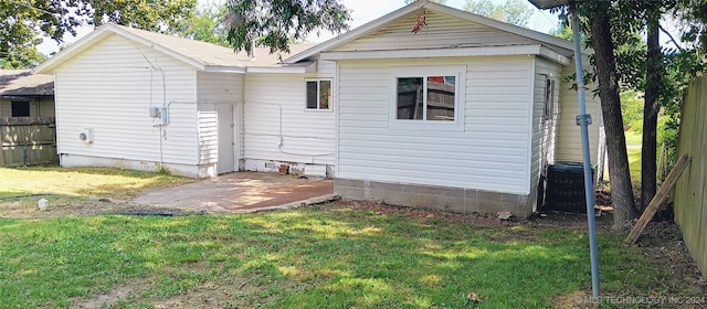 back of house with a yard and a patio area