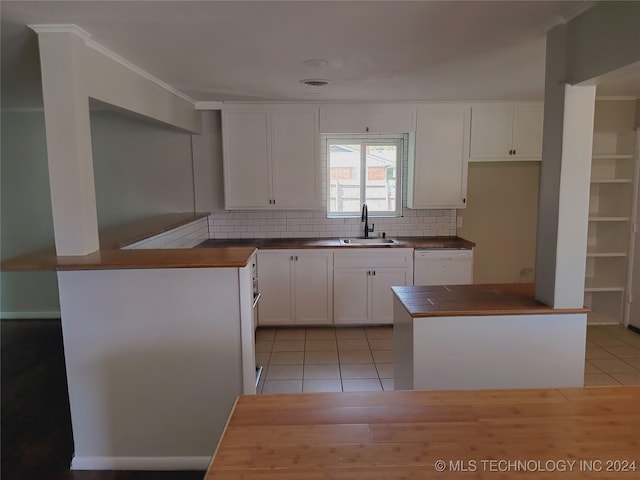 kitchen featuring light tile patterned floors, white dishwasher, white cabinetry, and sink