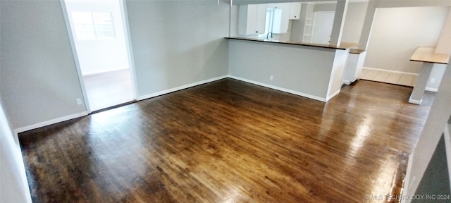 spare room featuring sink and dark hardwood / wood-style floors