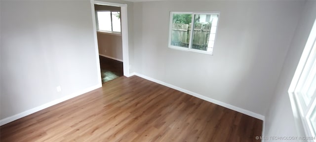 unfurnished room with hardwood / wood-style flooring