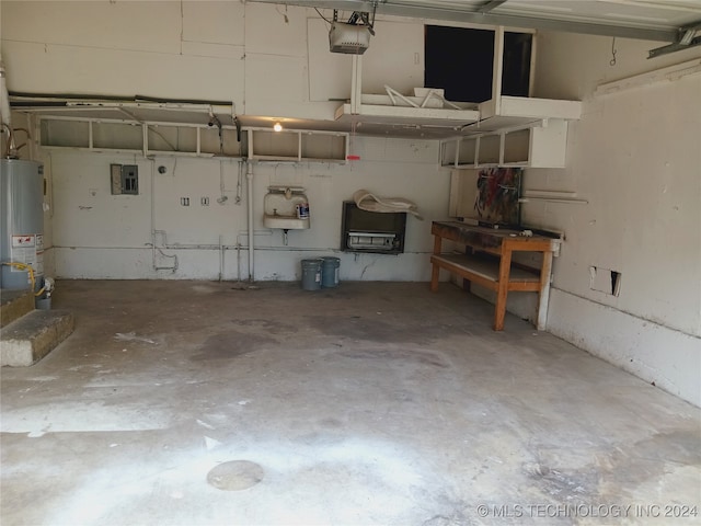 garage featuring water heater, a garage door opener, and electric panel