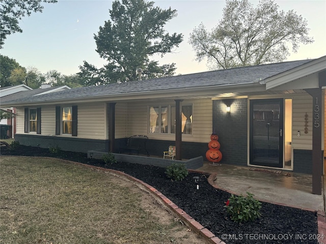 1335 N Mcfarland Pl, Claremore, OK 74017 - ranch-style house with brick siding, roof with shingles, a front yard, and a patio